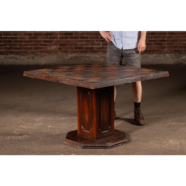 Decorative chess table featuring a carved wood game board mounted on a pedestal base and accompanied by a complete set of...