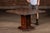 Decorative chess table featuring a carved wood game board mounted on a pedestal base and accompanied by a complete set of...