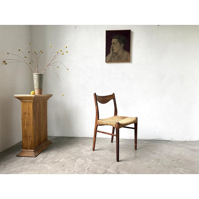 Maison Lecan presents this 1960s Scandinavian chair in exotic wood and straw, attributed to Arne Wahl Iversen. It is the...