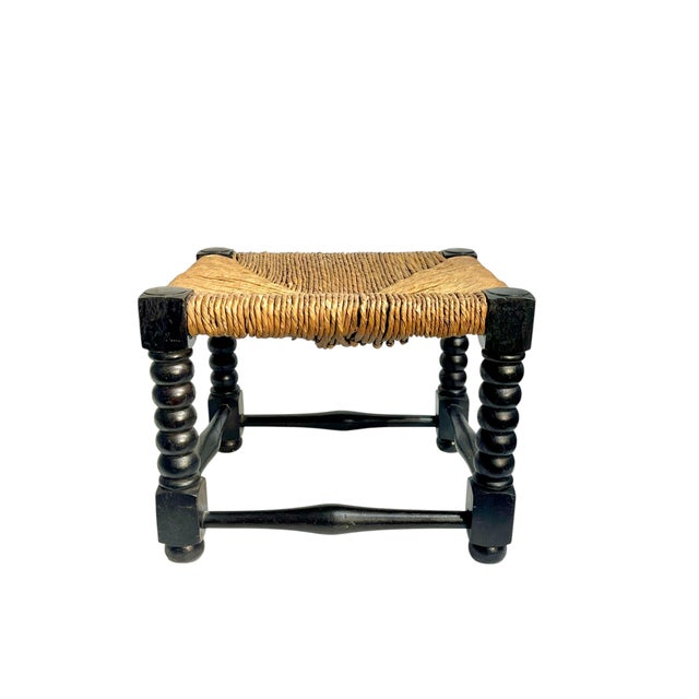 Antique English Jacobean style rush seat stool with bobbin legs. In original condition. Stool is oak with a very dark...