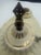 A charming vintage glazed porcelain ceiling fixture featuring an elongated sculptural form, glossy ivory/cream finish,...
