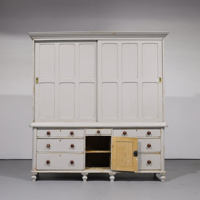 An impressive antique pine housekeeper’s cupboard with wonderful scale, storage, and timeworn character. The exterior has...