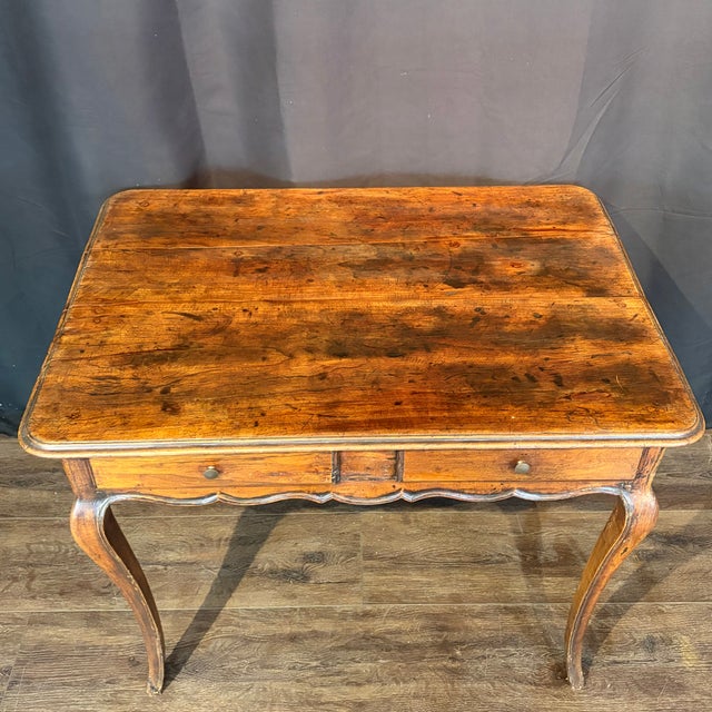 Elegant 19th century French walnut side table or writing desk with graceful Louis XV lines and a warm, beautifully aged...