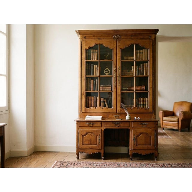 A grand scale 18th century French Louis XV Period bibliothèque, or bookcase, from the Loire Valley. Made of solid cherry...