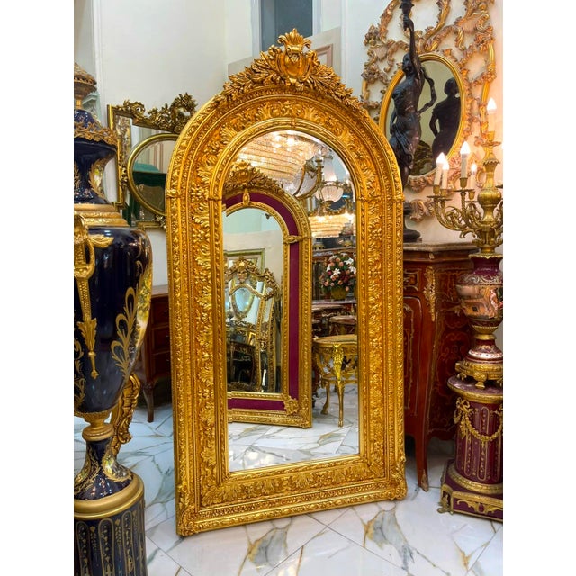 Create a truly majestic focal point with this grand French Baroque–style arched mirror, featuring an exceptionally ornate...