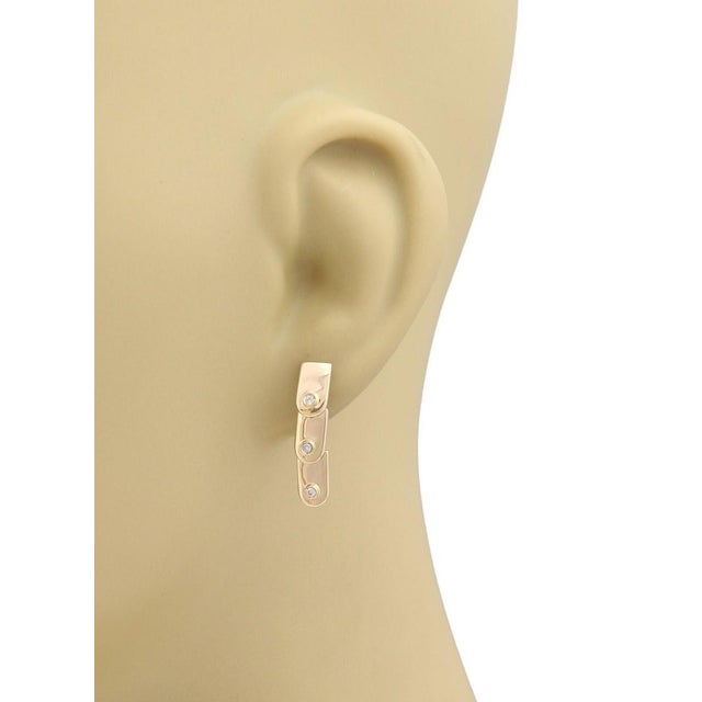 This authentic Gucci earring pair is crafted in solid 18k yellow gold with a high-polish finish. The elegant three-tier...