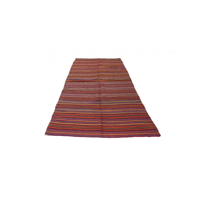 Handwoven vintage striped decorative kilim rug from Denizli region of Turkey. Approximately 50-60 years old. In very good...