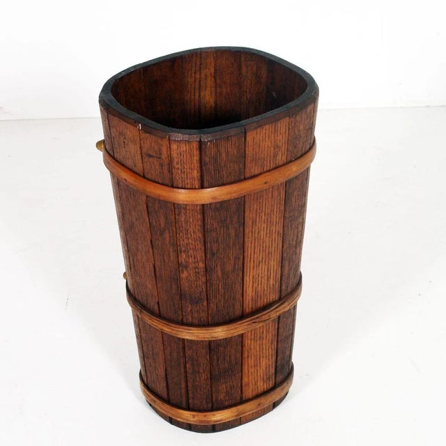 Umbrella stand in solid oak of the 20s Art Deco period, wax polished Dim. in cm: Height 45 cm, diameter 25 cm.