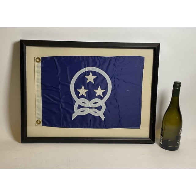 Nautical boat flag in frame. Yacht Club Commodores flag showing three stars surrounded by a knotted rope. White hoist with...