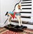 A hand-carved wooden horse painted white with colorful tack on a black rocking base. Product Information: Materials: Wood,...