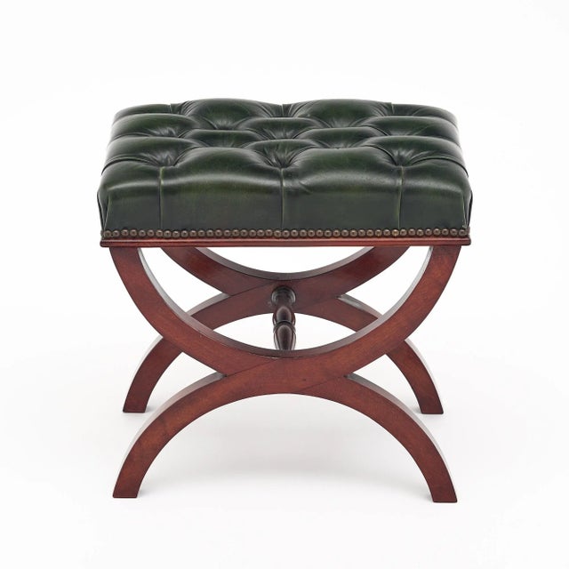 Curule stool from France made with a hand-carved solid mahogany base and original tufted leather upholstery. The...