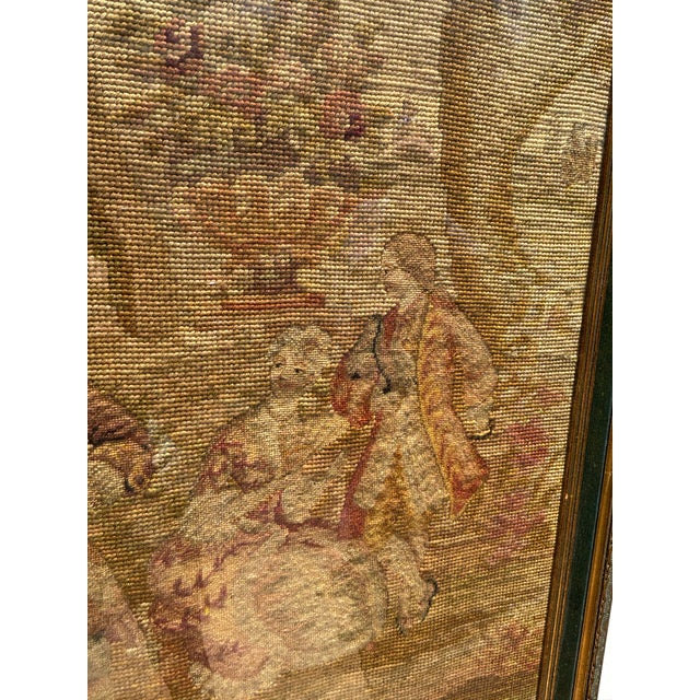 Framed needlepoint of two gentlemen courting a lady from turn of the century. Gold leaf frame.