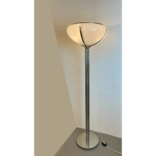 Iconic space-age floor lamp named quadriofoglio. Made of four branches of chromed metal that enfold an acrylic lampshade...