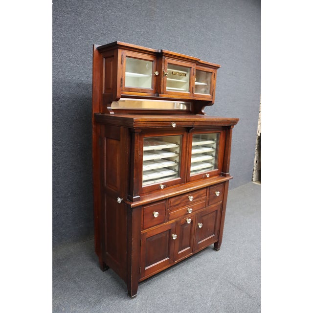 Rare American Dental Company dental sterilizer cabinet in solid mahogany. Features original glass-front upper cabinets...