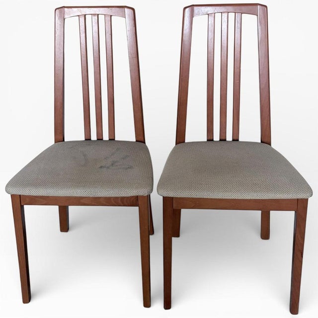 A handsome pair of mid century high back dining chairs by Morris of Glasgow, showcasing the clean architectural lines and...