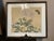 Vintage framed East Asian botanical painting, featuring soft pink roses, delicate green foliage, and a dark butterfly...