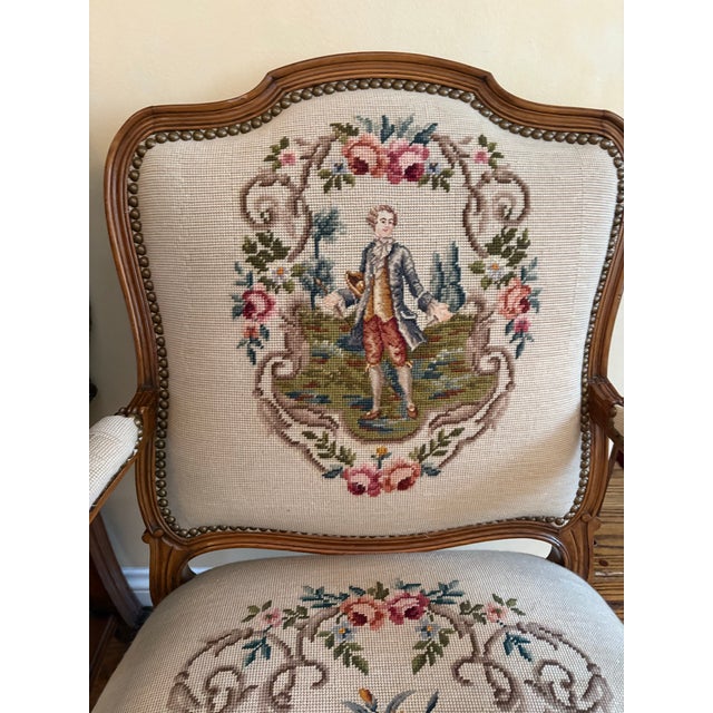 A magnificent matched pair of French Louis XV style fauteuils (open armchairs) upholstered in exquisite hand-stitched...