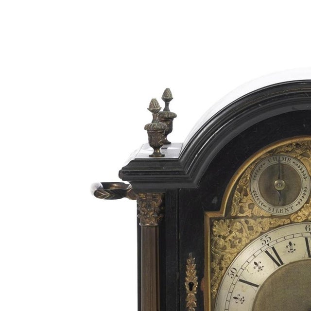 Table clock - George III - 19th century. 19th-century English clock, George III style. Darkened wooden case with embossed,...