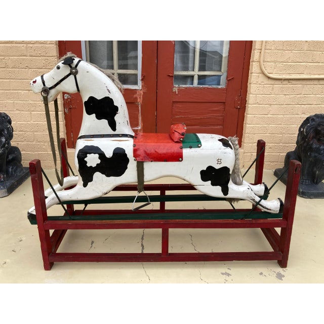 Hand carved hand painted wood rocking horse, with glass eyes, canvas and leather bridle halter, brass nails, vinyl tack...