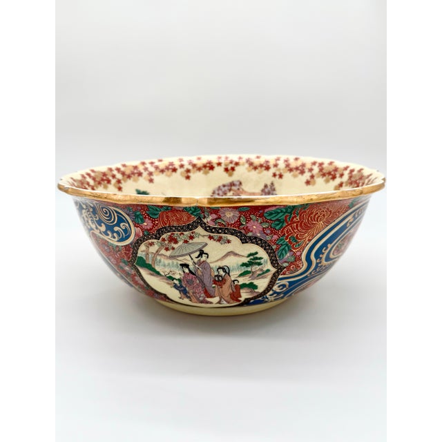 An extraordinary late Meiji-period Satsuma-style centerpiece bowl, hand-painted in a vivid polychrome palette with...