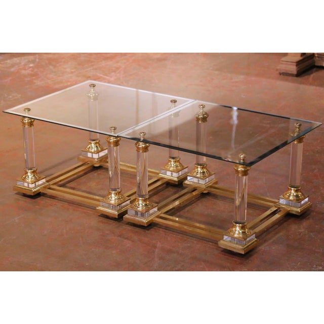 Crafted in France circa 1970, this elegant pair of side tables reflects the glamorous Hollywood Regency aesthetic through...