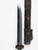 This is a decorative knife with a carved wooden sheath featuring floral and scroll designs accented by colored stones. The...