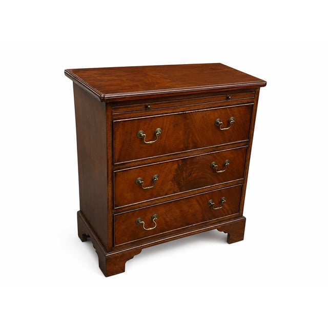 A handsome reproduction 3-drawer mahogany crotch dresser with richly figured drawer fronts, warm reddish-brown finish, and...