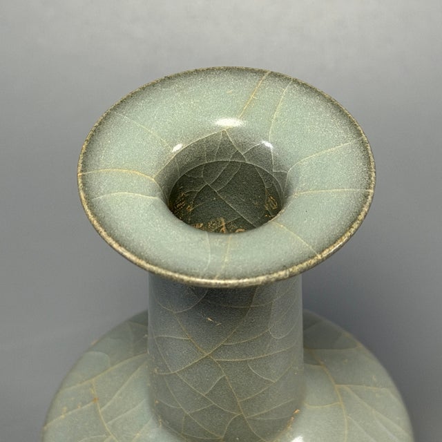 Antique Chinese Guan‑style porcelain vase. Beautiful natural crackle glaze all over the surface, elegant tall neck shape....