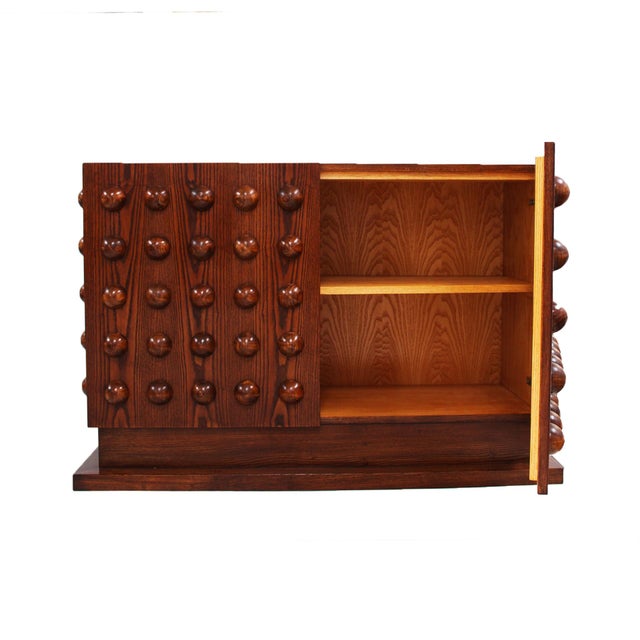 Italian Brutalist-style sideboard handcrafted in oak wood. The two doors feature a striking geometric composition of hand-...