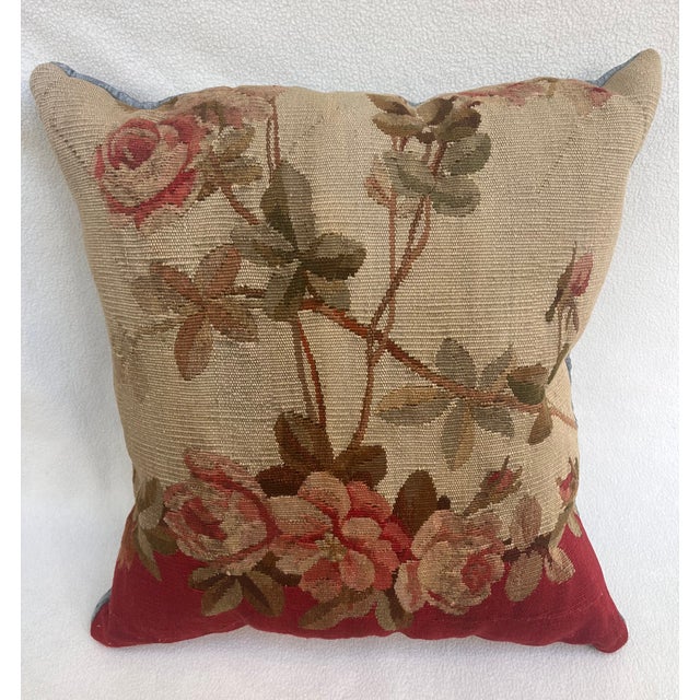 Decorative pillow upholstered in richly woven 19th century Aubusson tapestry, adorned with an elegant floral motif. A...
