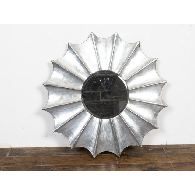 A vintage Italian silver leaf sunburst mirror from the mid 20th century, with radiating effects and beveled mirror plate....