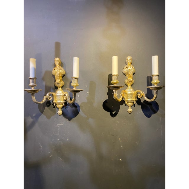 A pair of circa 1900s Caldwell silver plated sconces with cherub atop