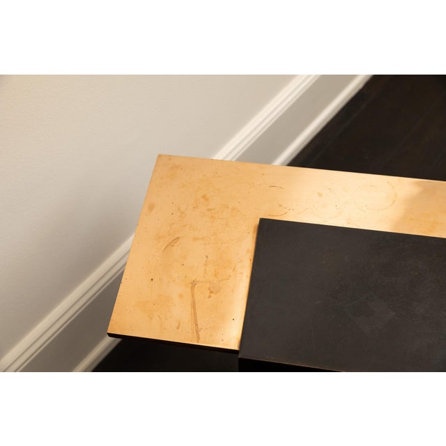 Eric Schmitt’s sculptural bronze corner table for Christian Liaigre evokes serene minimalism with its patinated black...