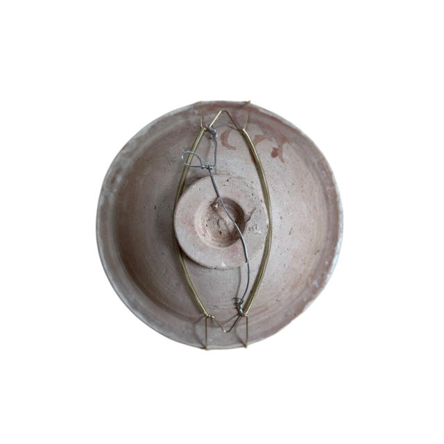 A beautifully handcrafted studio pottery bowl featuring an abstract floral motif rendered in earthy brown linework with...