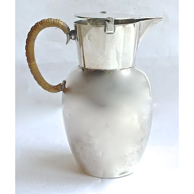 Vintage; 1910-1960, Mid-Century Modern, WMF, German, silverplated pitcher with flip-top lid and spout. Handle has reed...