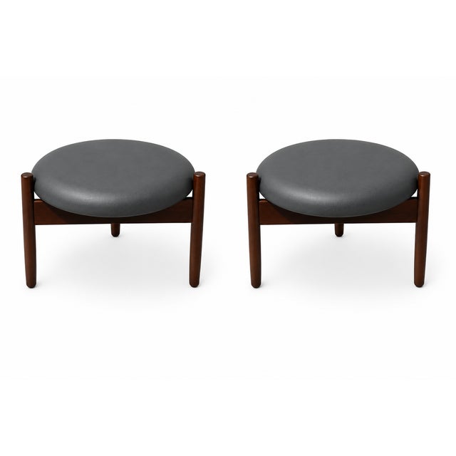 Mid century style walnut and black leather ottomans. Manner of Hugo Frandsen in the 1960s . Well made 3 legs, solid...