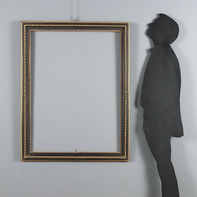 Neoclassical frame in ebonized fruitwood. Double carved and gilded molding alternating with ebonized moldings. Italy, late...