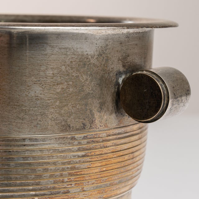 This mid 20th century Art Deco ice bucket from France is finished in silver. It is fitted with a pair of ring handles,...