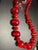 MCM necklace features graduated, vibrant red cats eye lucite beads interspersed with cherry red faceted glass. The larger...
