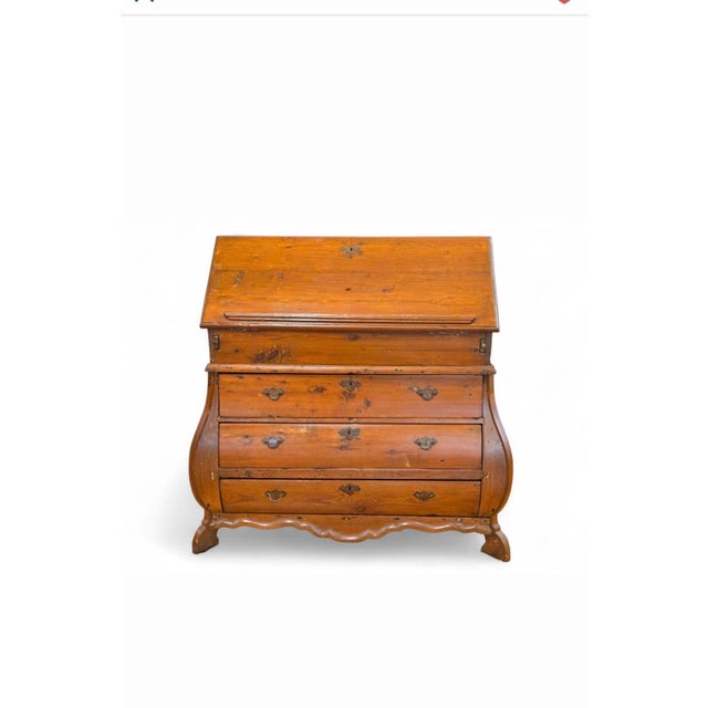 An exceptional and character-rich 18th century Dutch bombe secretary desk, crafted in warm, honey-toned pine and retaining...