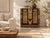 Brass does the work on this chest: engraved plates, pyramid studs and strap fittings cover a dark-stained front, with...