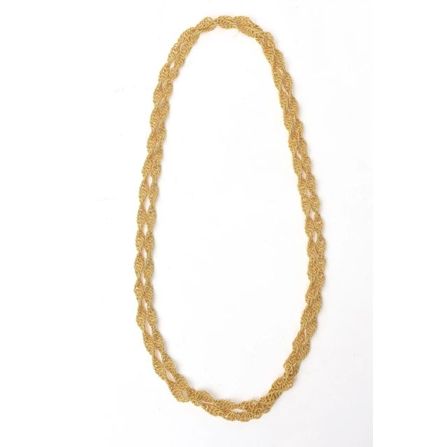 This is part of Chairish’s Costume Jewelry assortment. This fabulous long 1960's spiral chain wrap necklace is all gold...