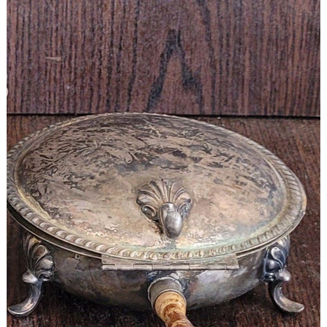 Late 1800s Silverplate Chafing Dish, Ornate Tripod Legs, Mask Motifs, Brass Interior, Wooden Handle Features Silverplate...