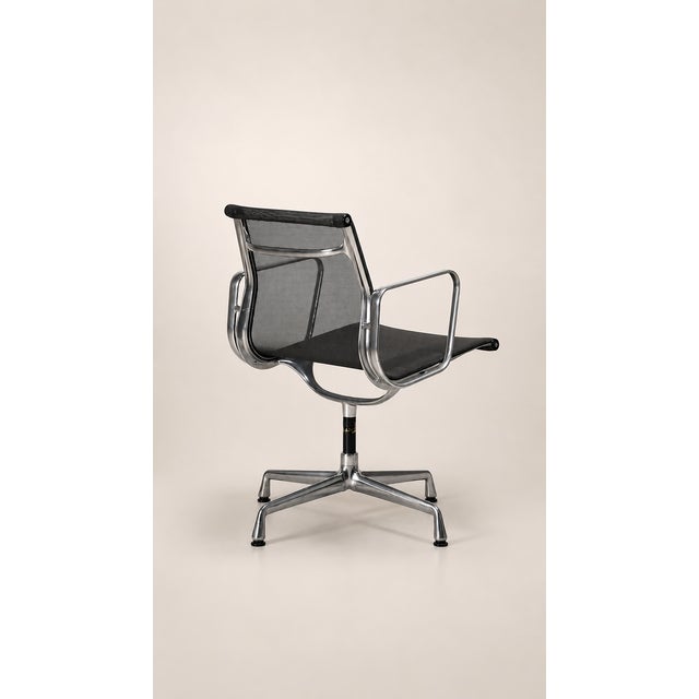Set of two Vitra Aluminium Chair EA 103 designer armchairs, created by Charles & Ray Eames. Polished aluminium frame,...