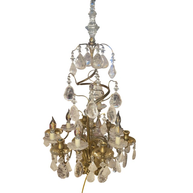 An exquisite pair of Italian 19th century girandoles richly adorned with abundant rock crystal and crystal elements. These...
