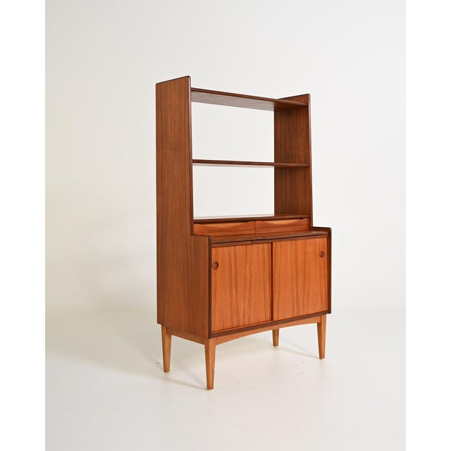 Bookcase with storage, pull-out shelf, and two drawers. Original Bräntorps label. Sweden, 1960s. Designed in keeping with...