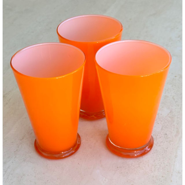 Set of 3 cased glasses in a bright orange. Set of 4 matching yellow glasses and 2 shorter lime green available separately...