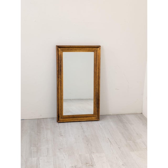 Mirror in a gilded wooden frame This mirror in a gilded wooden frame makes a beautiful addition to any interior. The frame...