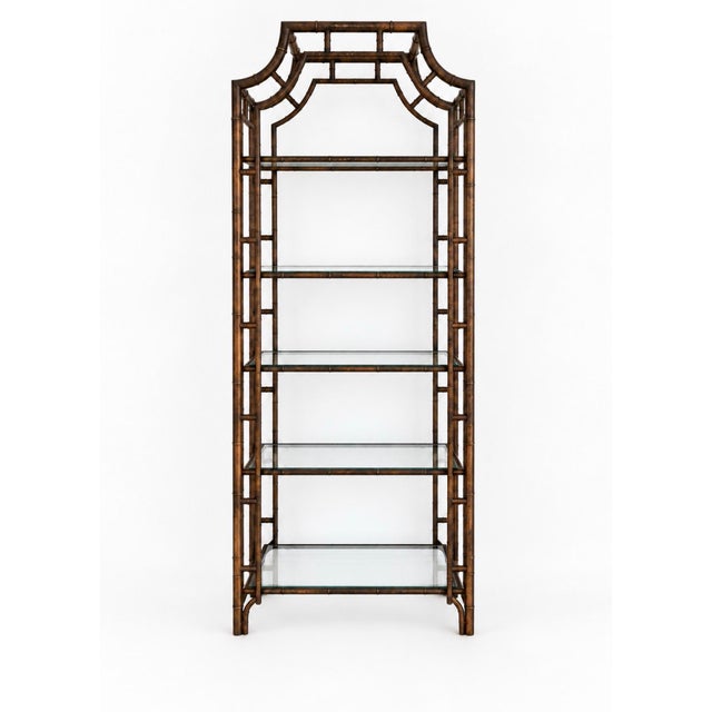 Elevate any interior with this exceptional pair of vintage Hollywood Regency faux bamboo étagères featuring dramatic...