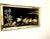 Large, elegant, framed black glass is etched with gold tone metal applique to create a serene scene of golden herons,...